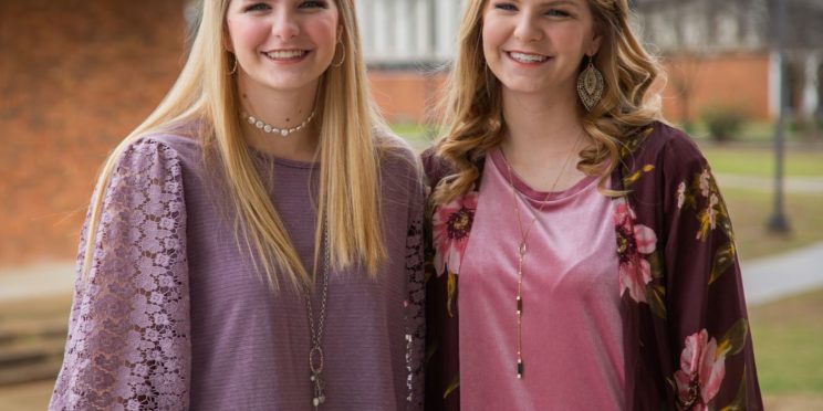 l-r: Victoria McDaniel and her sister Olivia McDaniel embrace outside the Harris College of Business building on campus. Both are Faulkner Admission Counselors and graduating seniors.