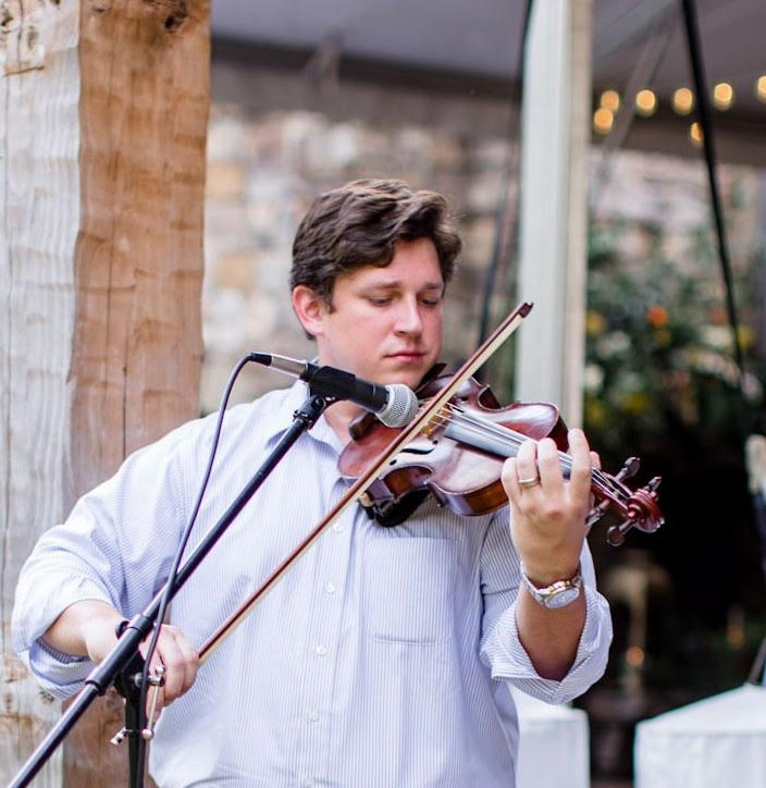 Westley Schlundt plays the violin for an event. As a musician, he was honored as the Faulkner Young Alumnus for the Music Department.