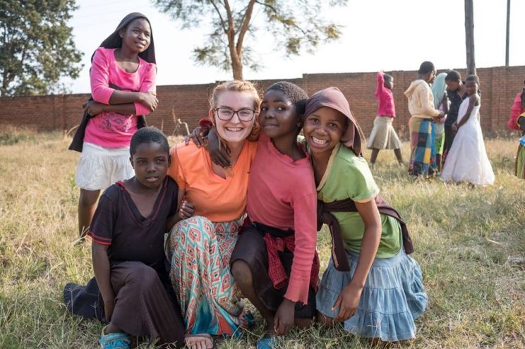 Ashley Ingwersen poses with children she served in the Mtendere Village in Malawi.