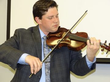Westley Schlundt plays his violin during the 2019 Marketplace Faith Friday Forums.