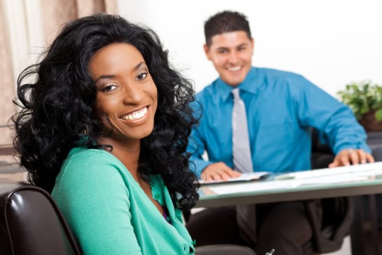Woman Smiling While At Office With Advisor