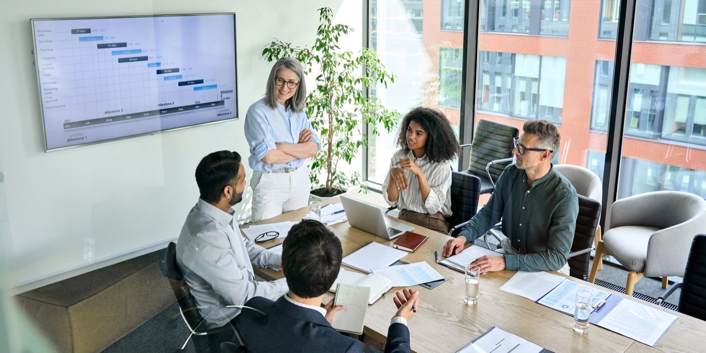 Diverse corporate team working together in modern meeting room office. Business team meeting at conference table