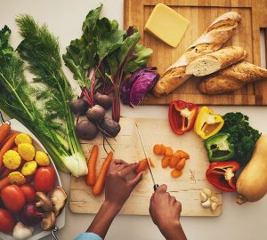 Vegetables Being Chopped Up on Cutting Board