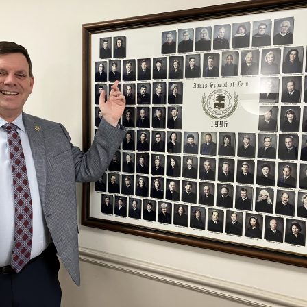 Daryl Bailey points to a picture of himself with the Faulkner Law graduating class of 1996.