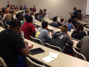 College Students in Classroom Listening to Instructor