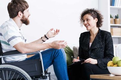 Man in Wheel Chair Talking to Counselor