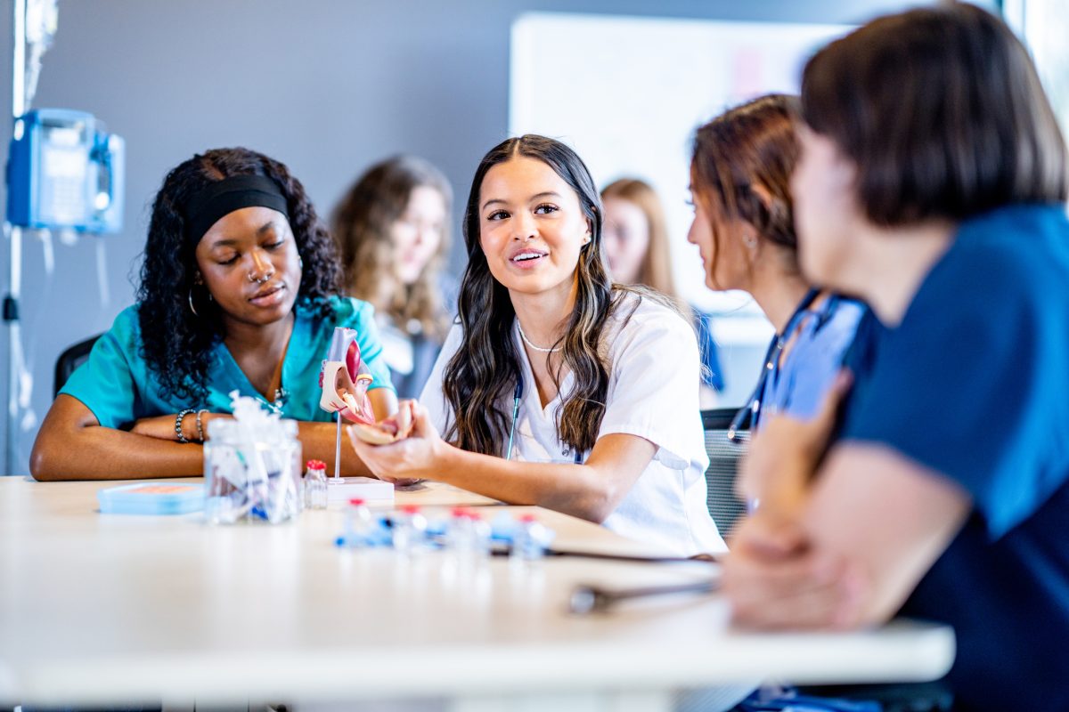 Group of nursing students studying sitting at desk