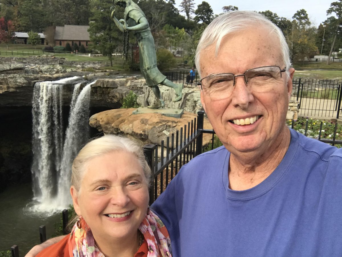 Peggie and Randall Haney share how God's blessings helped them support Faulkner. they pose in front of Noccalula Falls in Gadsden, AL.