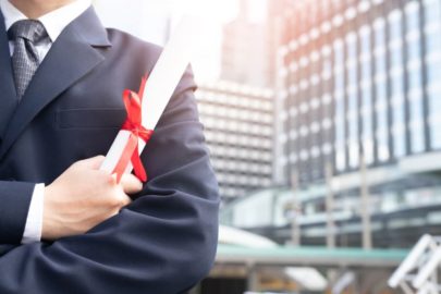 Man holding his business degree