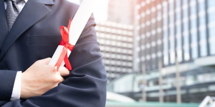 Man holding his business degree