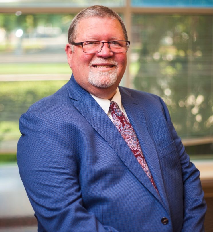 Mike Horn poses in a suit as the new Director of Biblical Studies Recruitment and Giving.