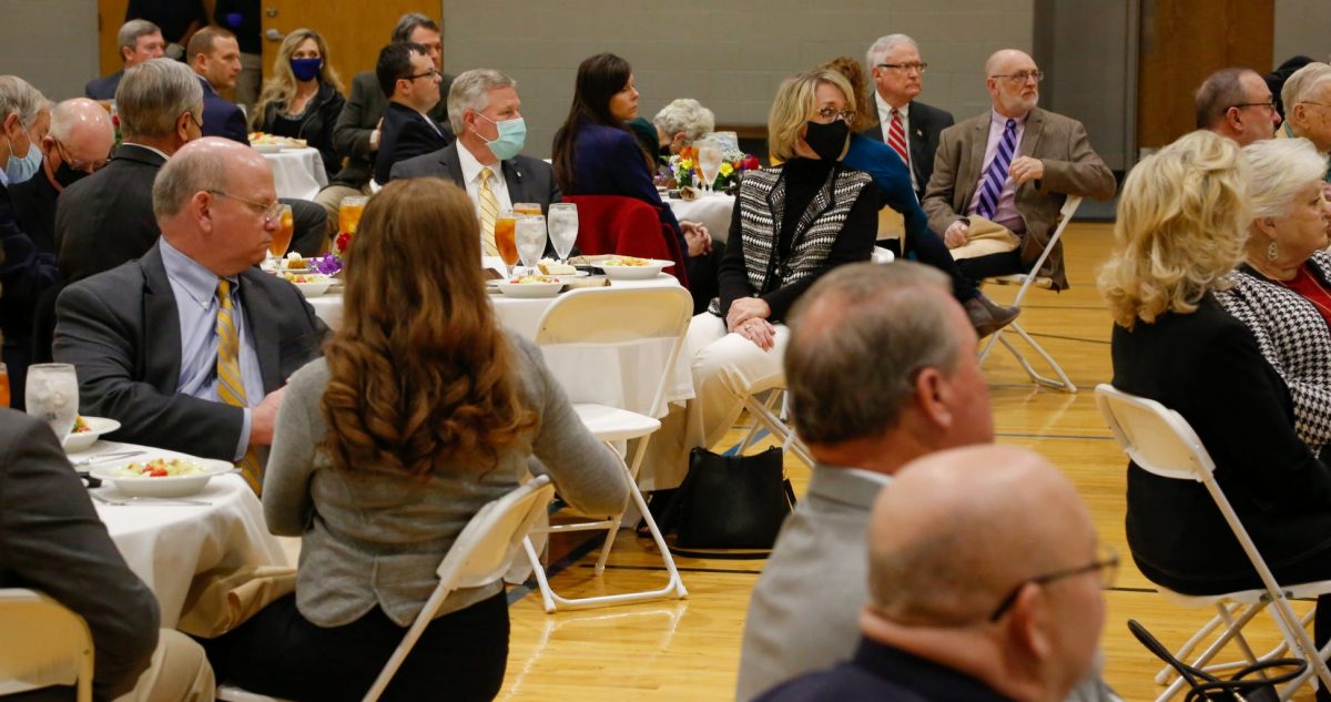 President Mike Williams, left and his wife Lisa Williams, right sit at a table during the President's Circle luncheon on Feb. 18, 2021.