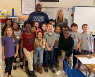 Quanterio Stokes stands among students from his elementary school.