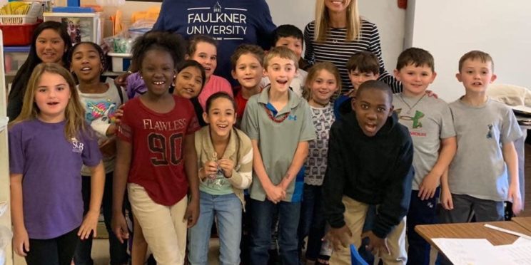 Quanterio Stokes stands among students from his elementary school.