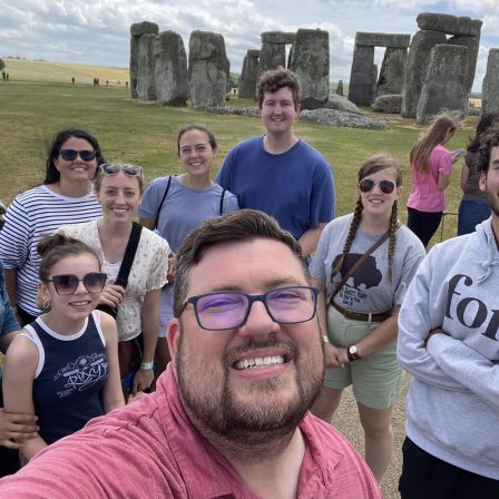 Peyton Jenkins takes a picture with the Great Books Study Abroad group in front of Stonehenge.